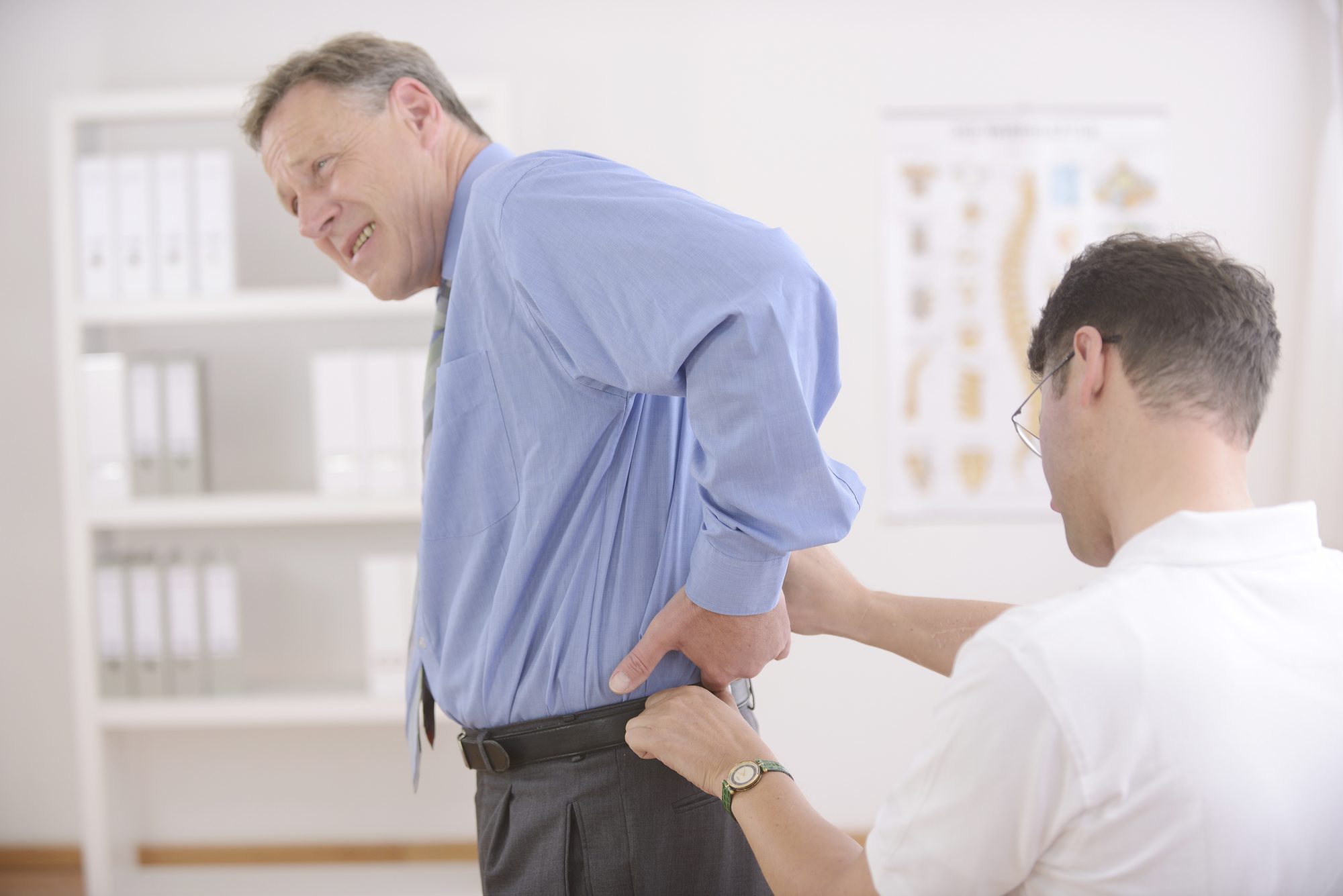 Chiropractor Examining Senior Man